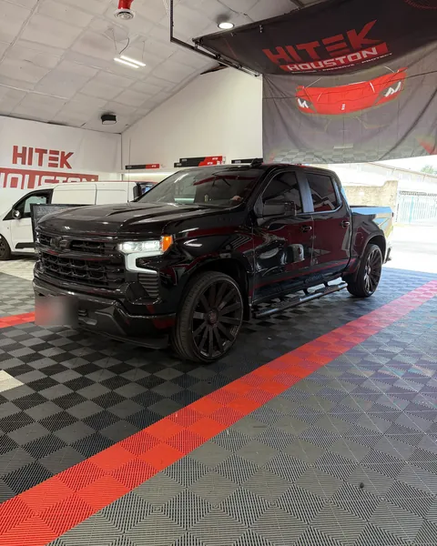 Black Chevrolet Silverado 1500 on black wheels with ceramic window tint