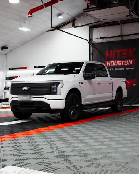 White Ford F-150 Lightning pickup with ceramic window tint