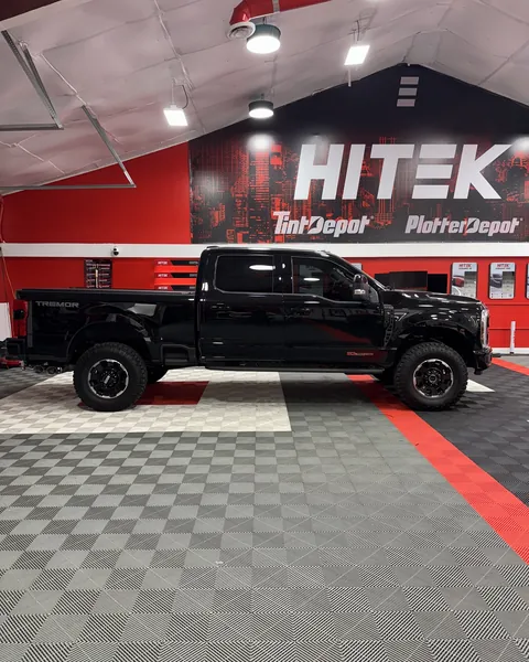 Black Ford Super Duty crew cab, side view, with ceramic window tint