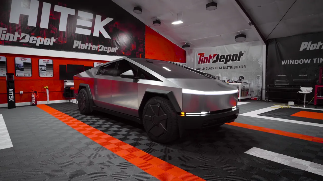Stainless steel Tesla Cybertruck with ceramic window tint after the install, parked in a tint studio
